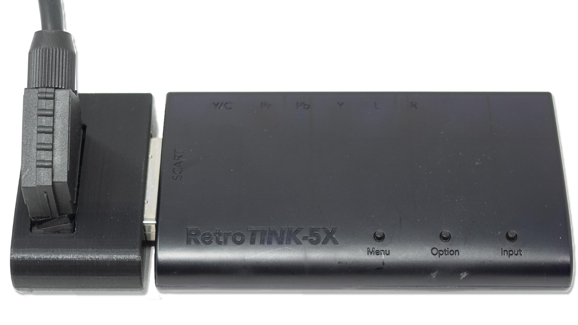 A SCART adapter connected to a retro video setup