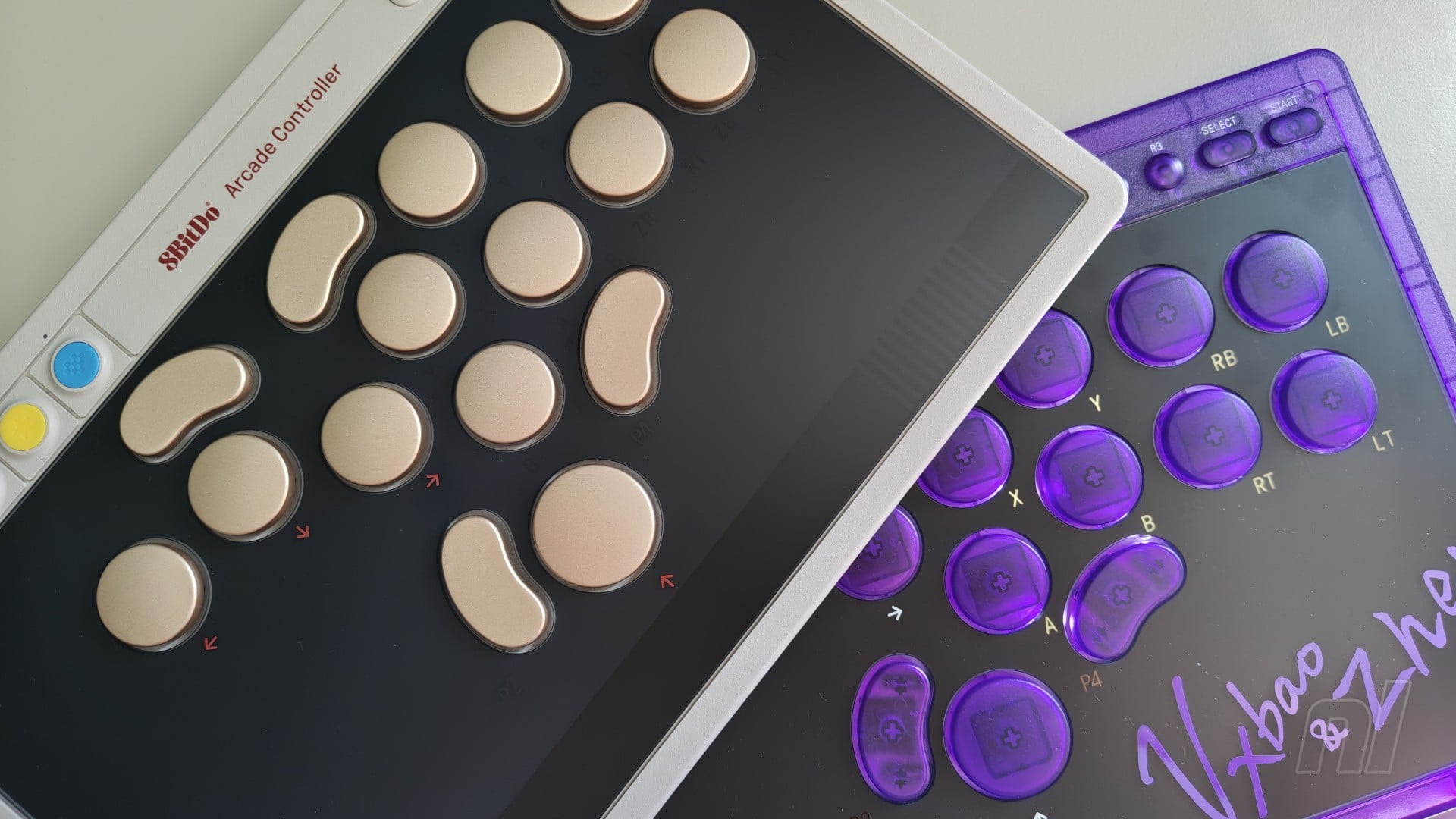 The 8BitDo Arcade Controller Signature Edition in transparent purple with arcade-style buttons.