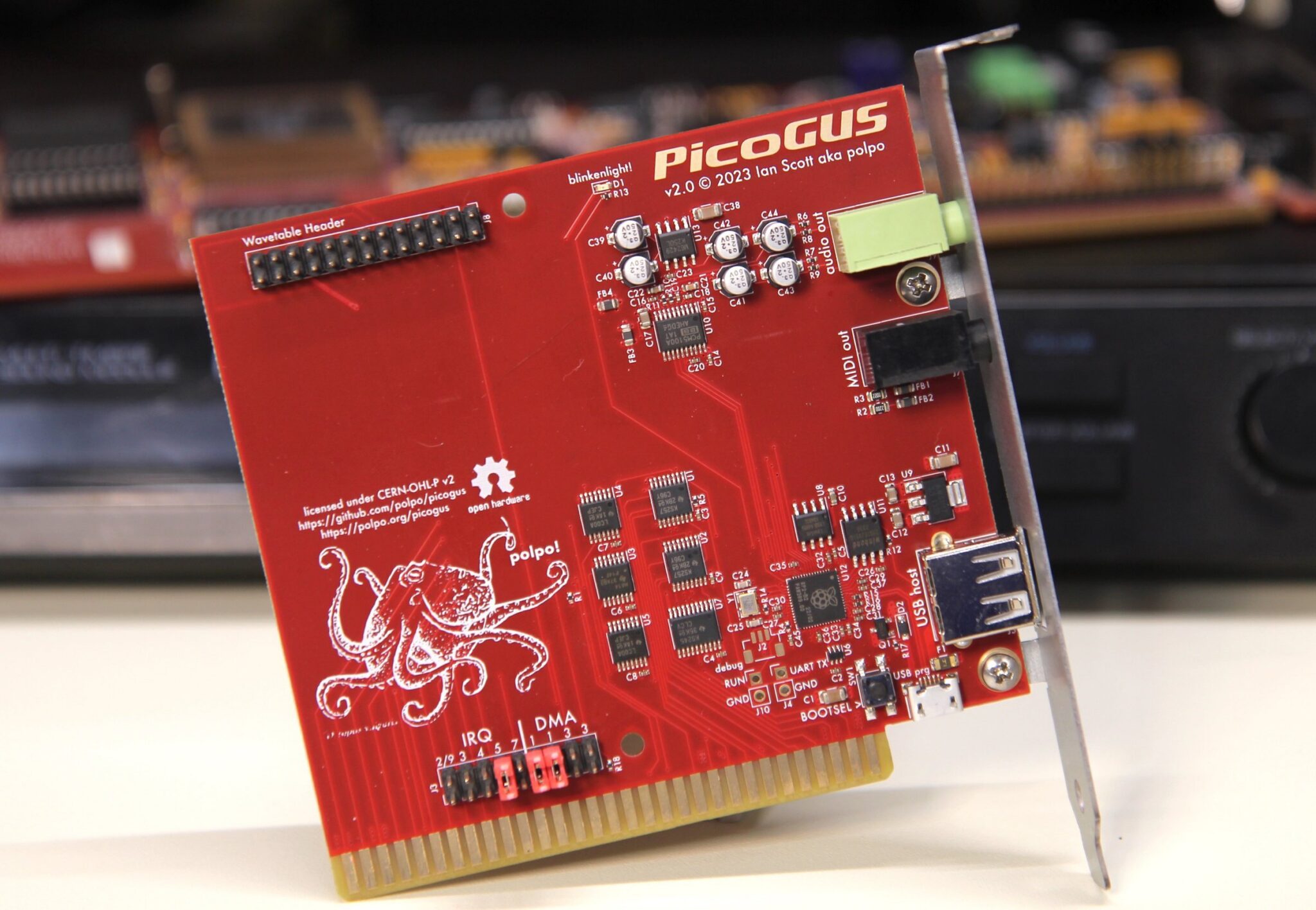 A vintage desktop PC setup with an ISA-style sound card, microSD media, and small modern development boards on the work: