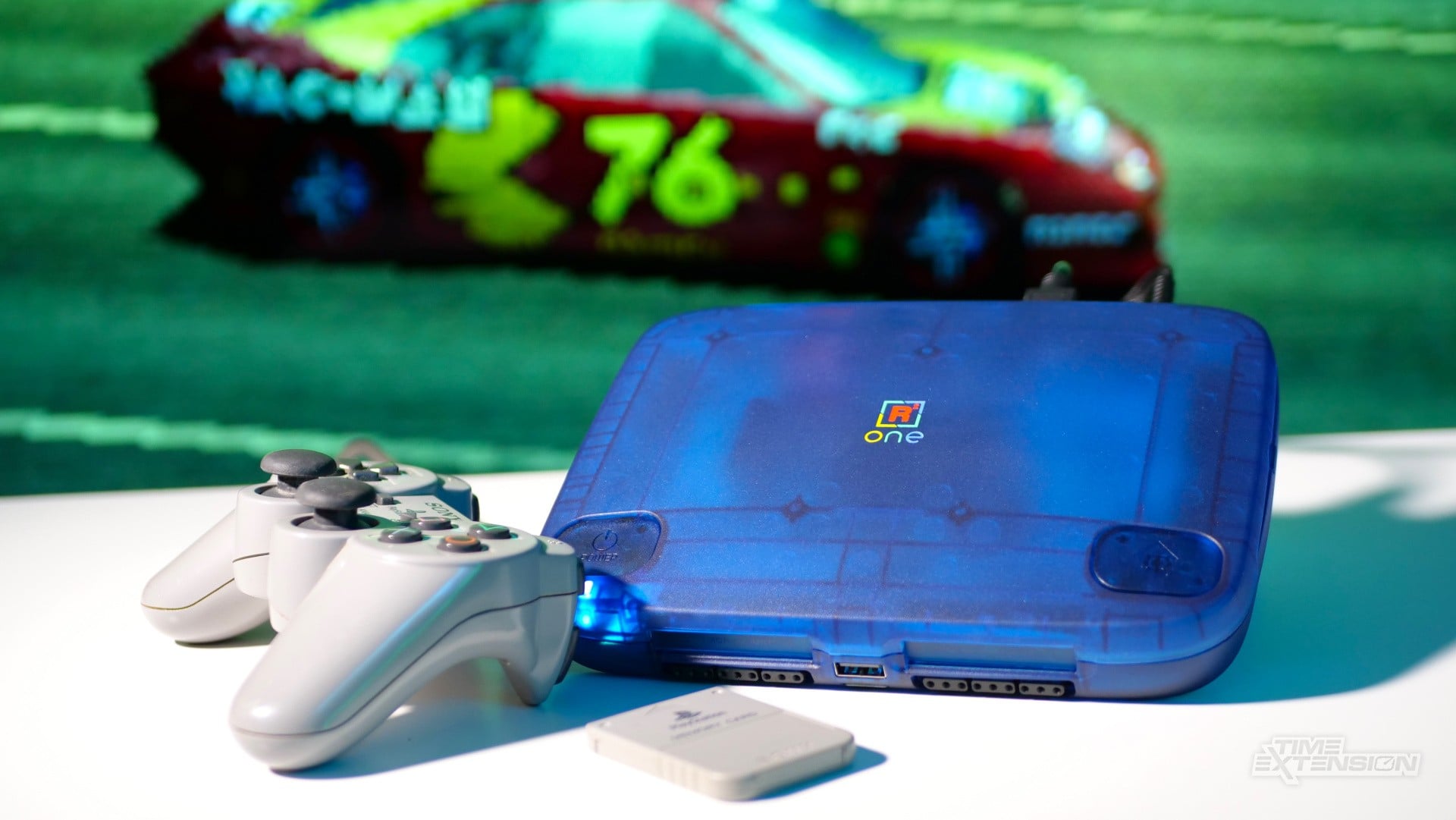A transparent blue SuperStation One FPGA console styled after the compact PSOne design.